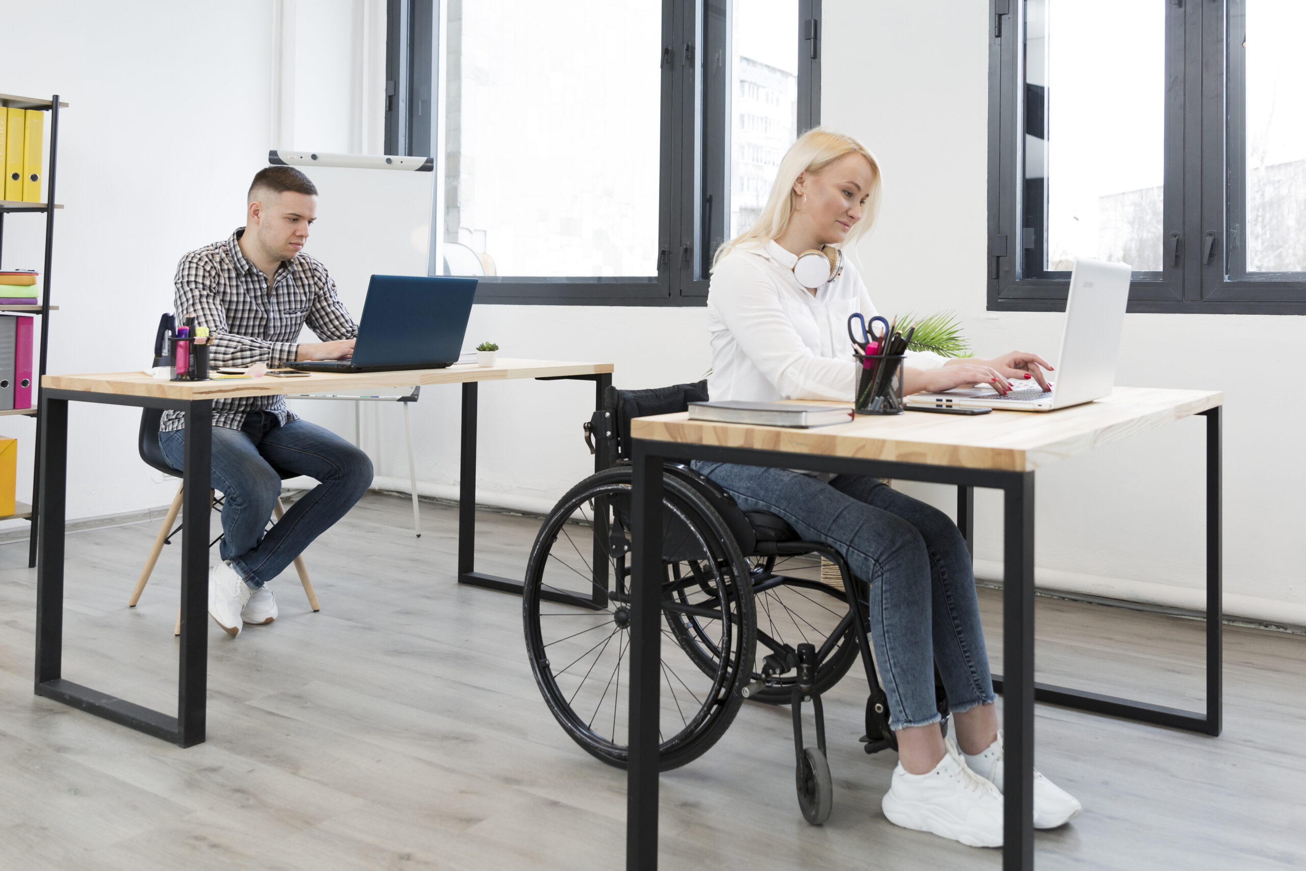 side-view-woman-wheelchair-working-form-her-desk